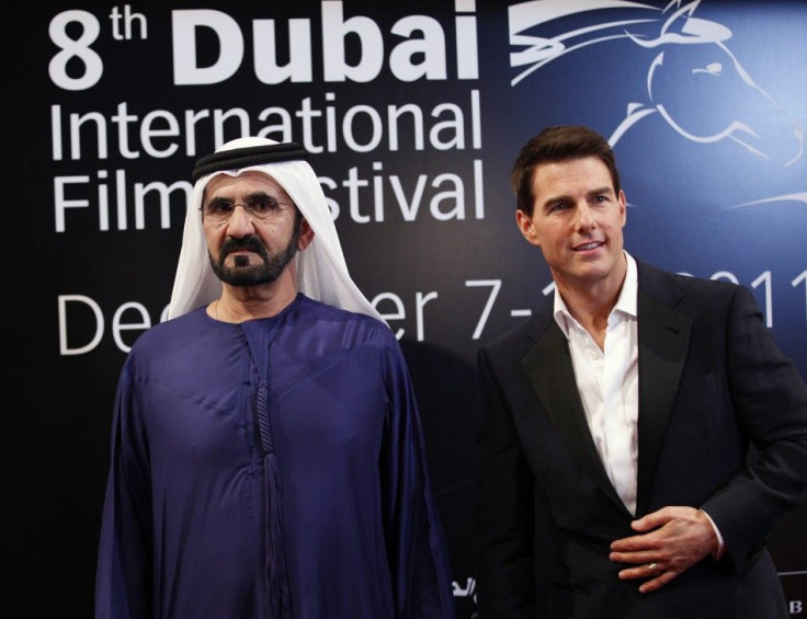 Sheikh Mohammed bin Rashid Al Maktoum (L), vice-president of the UAE and ruler of Dubai, poses at the red carpet with U.S. actor Tom Cruise as they arrive during the opening ceremony of the 8th Dubai International Film Festival for the premiere of Cruise&