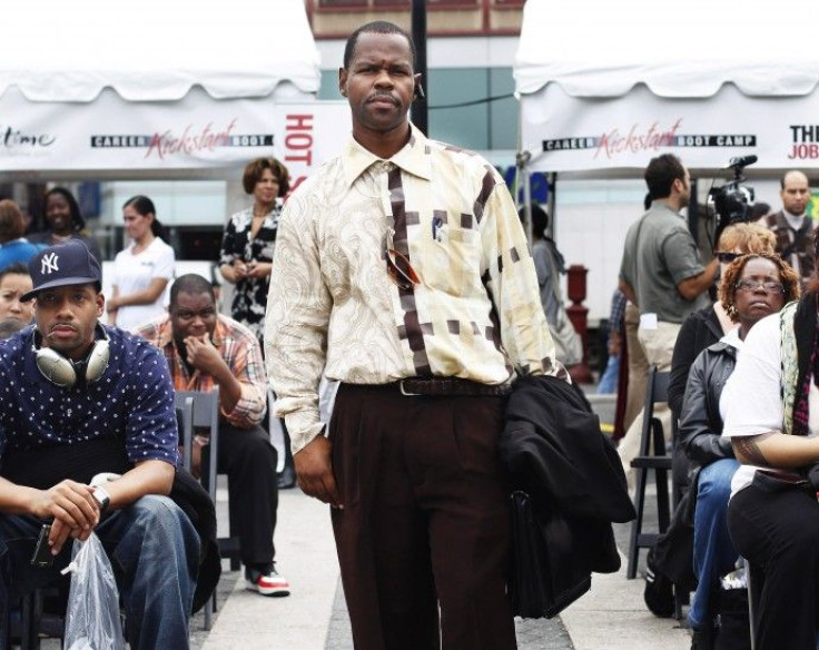 A man listens to job consultants during a job fair at Union Square in New York