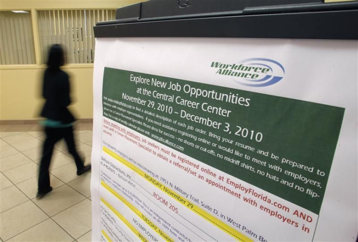 A job seeker walks past a sign at the Workforce Alliance Career Center in West Palm Beach