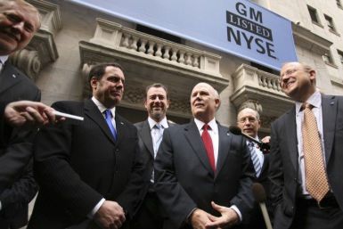 General Motors executives are seen outside the New York Stock Exchange building as GM's common stock begins trading publicly again