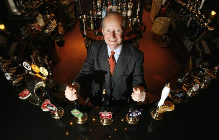 Chairman Michael Turner poses at a beer pump