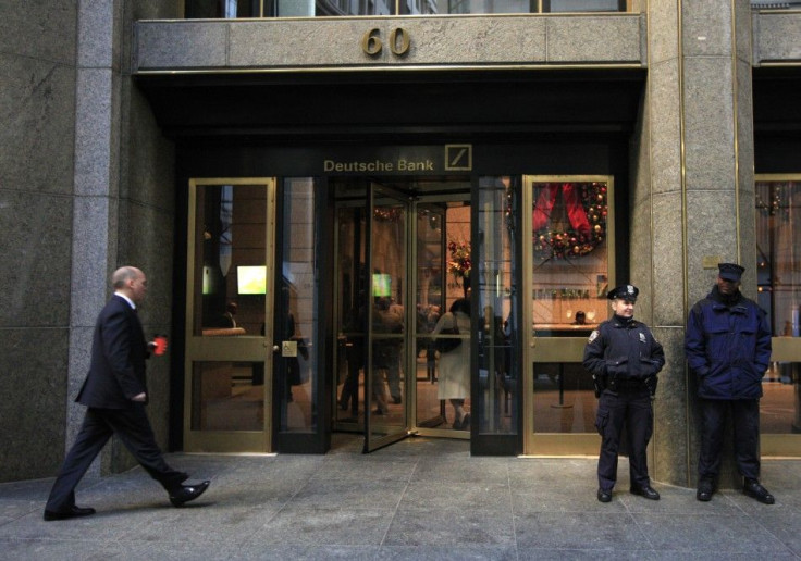 A New York City Police Officer stands beside a security officer at the entrance of a Deutsche Bank office in New York