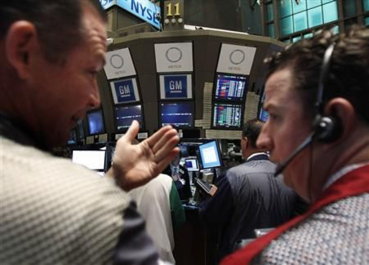 Traders gather around the General Motors trading post on the floor of the New York Stock Exchange