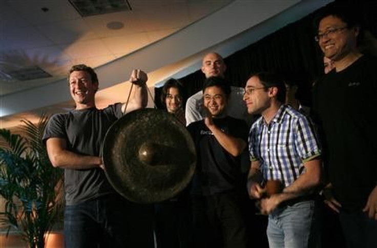 Facebook CEO Mark Zuckerberg (L) holds a gong while celebrating with members of his staff after unveiling the company&#039;s new location services feature called &quot;Places&quot; during a news conference at the Facebook headquarters in Palo Alto, Califo