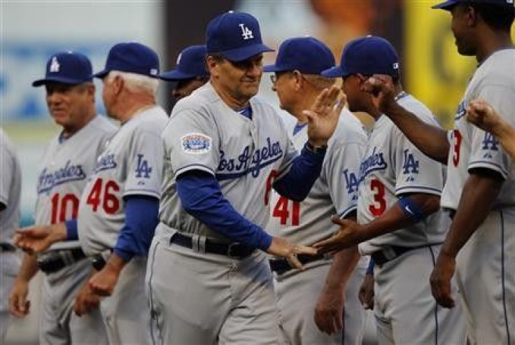Los Angeles Dodgers manager Joe Torre shakes hands with members of his team before their MLB National League baseball game against the Florida Marlins in Miami, Florida