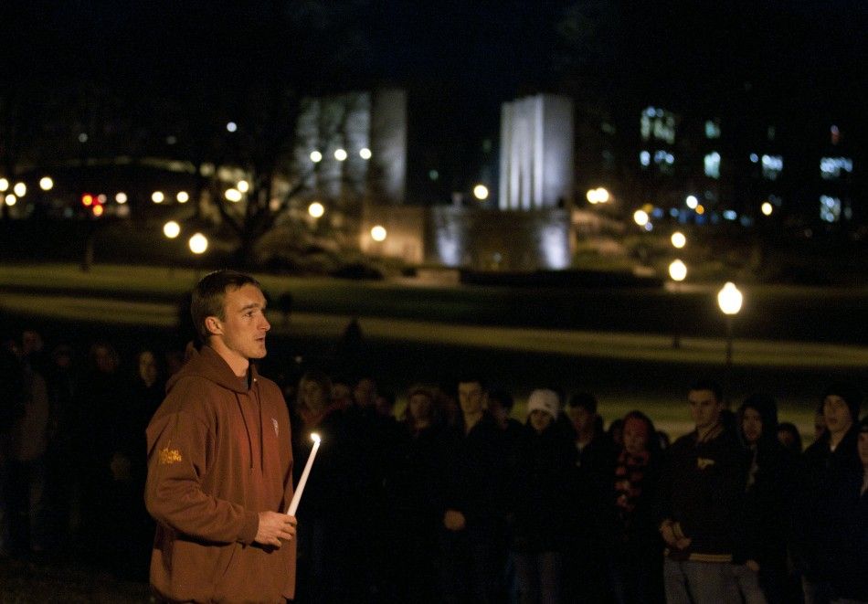 Virginia Tech student Chris Mundy speaks to fellow students at an impromptu memorial for the Virginia Tech police officer who was killed earlier on campus at Virginia Tech University Blacksburg, Virginia