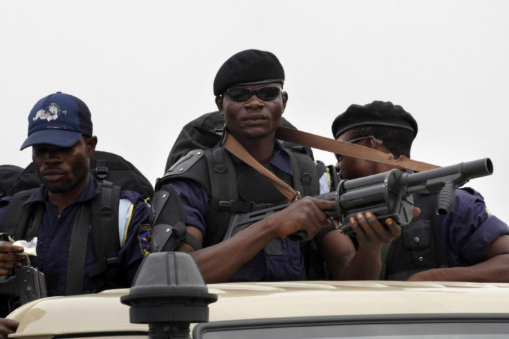 A riot policeman sits atop a minibus in Democratic Republic of Congo&#039;s capital Kinshasa