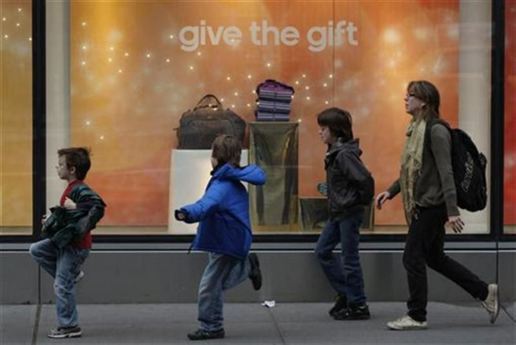 Children run past a storefront decorated for the holidays in New York