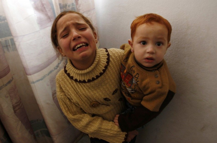 The daughter of militant Al-Batsh mourns as she holds her brother during their father&#039;s funeral in Gaza City
