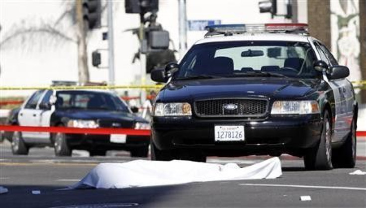 A body is covered by a blanket after a shooting with police in Hollywood, California