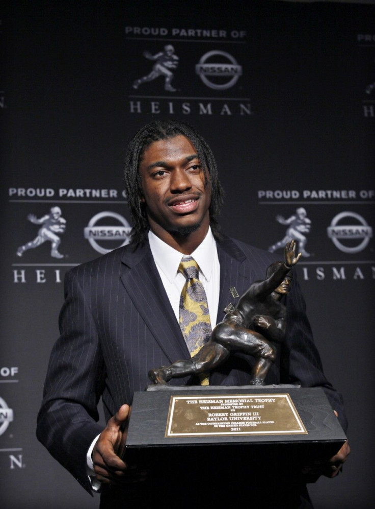 Baylor University quarterback Robert Griffin III holds the Heisman Memorial Trophy - Dec. 10, 2011