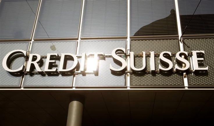 The sun is reflected at the logo of Swiss bank Credit Suisse at a branch office in Basel