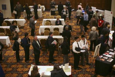 Job seekers stand in line to speak with employers at a job fair in San Francisco, California November 9, 2011.