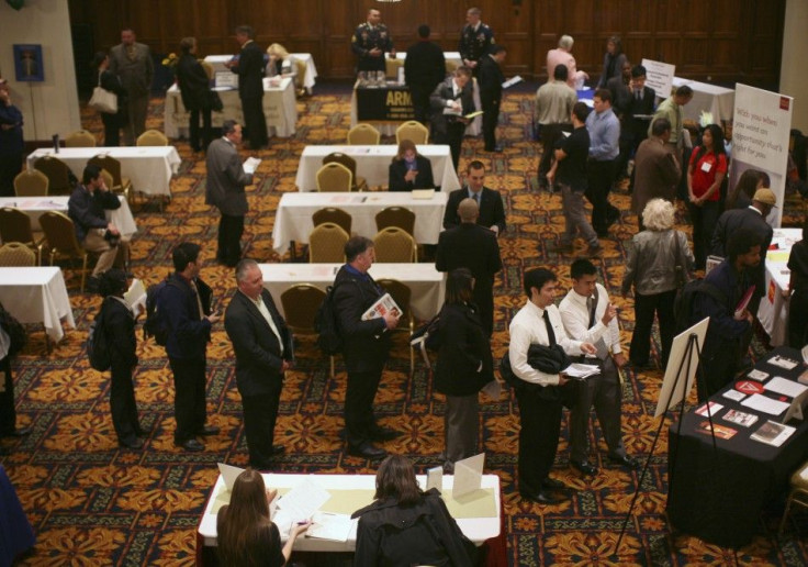Job seekers stand in line to speak with employers at a job fair in San Francisco, California November 9, 2011.