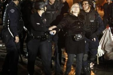 Los Angeles Police Department officers arrest an Occupy LA protester at the encampment at LA city hall