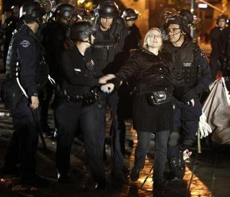 Los Angeles Police Department officers arrest an Occupy LA protester at the encampment at LA city hall