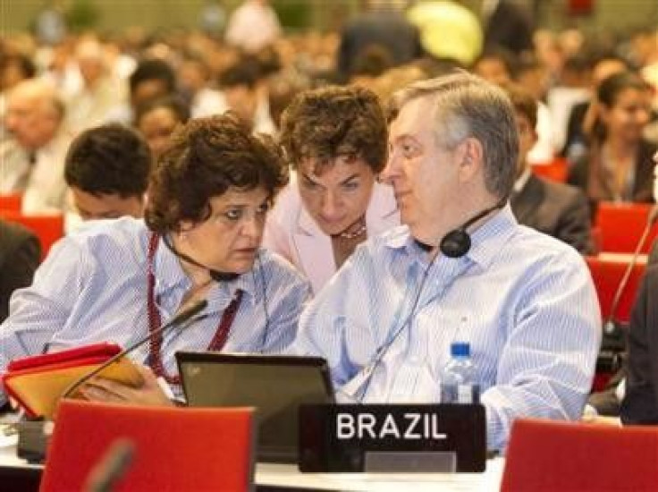 United Nations (UN) Framework Convention on Climate Change Executive Secretary Christiana Figueres speaks with Brazil&#039;s Minister of Environment Izabella Teixeira (L) and chief climate envoy Luiz alberto Figueiredo during a plenary session at the Unit