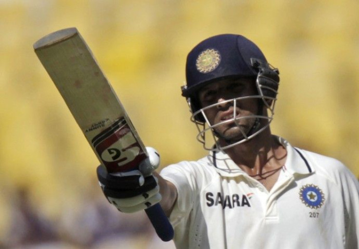 India's Dravid raises his bat after scoring a century against New Zealand on the third day of their third and final test cricket match in Nagpur.