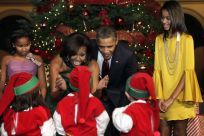 U.S. President Barack Obama and family greet children, dressed as elves, at the &quot;Christmas in Washington&quot; celebration in Washington