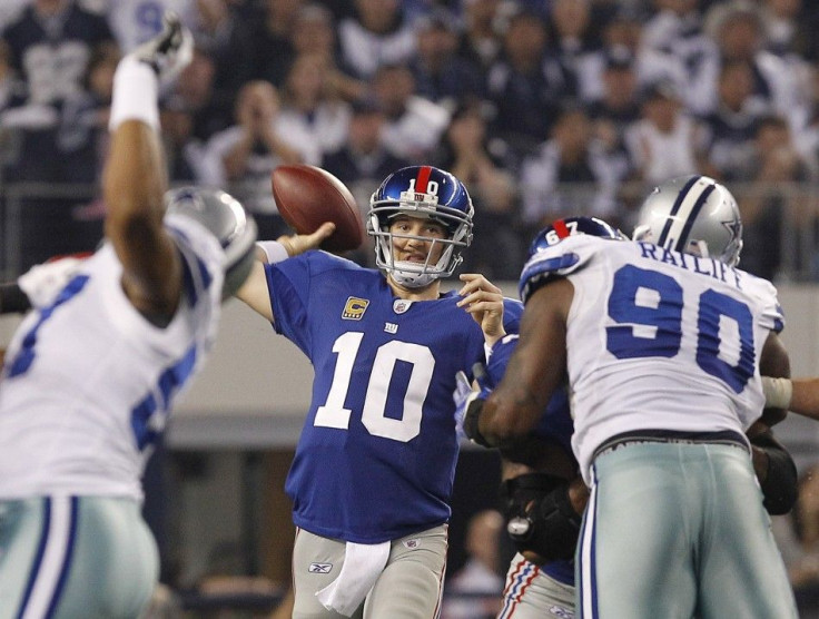 New York quarterback Manning throws a pass as he is pressured by Dallas defensive tackle Ratliff in the first half of their NFL football game in Arlington, Texas