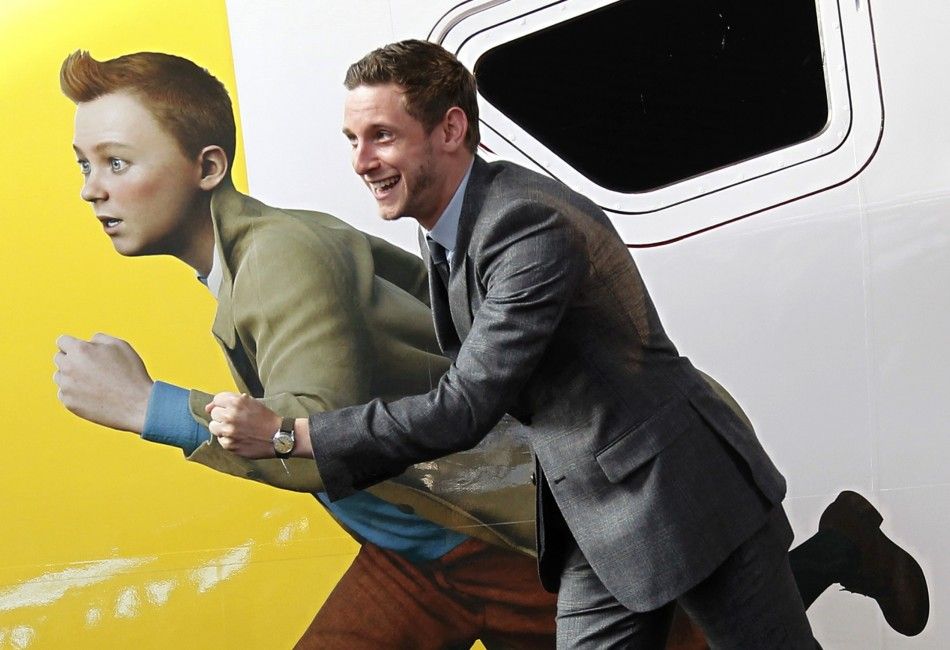 Actor Bell imitates a figure of Tintin painted on a Thalys high-speed train in Brussels