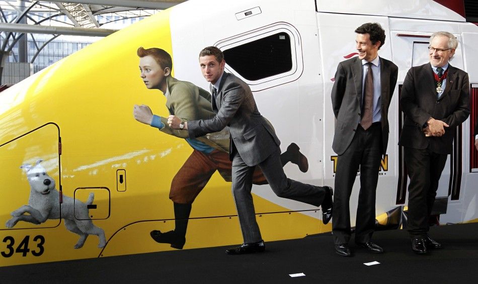 Actor Bell imitates a figure of Tintin painted on a Thalys high-speed train in Brussels