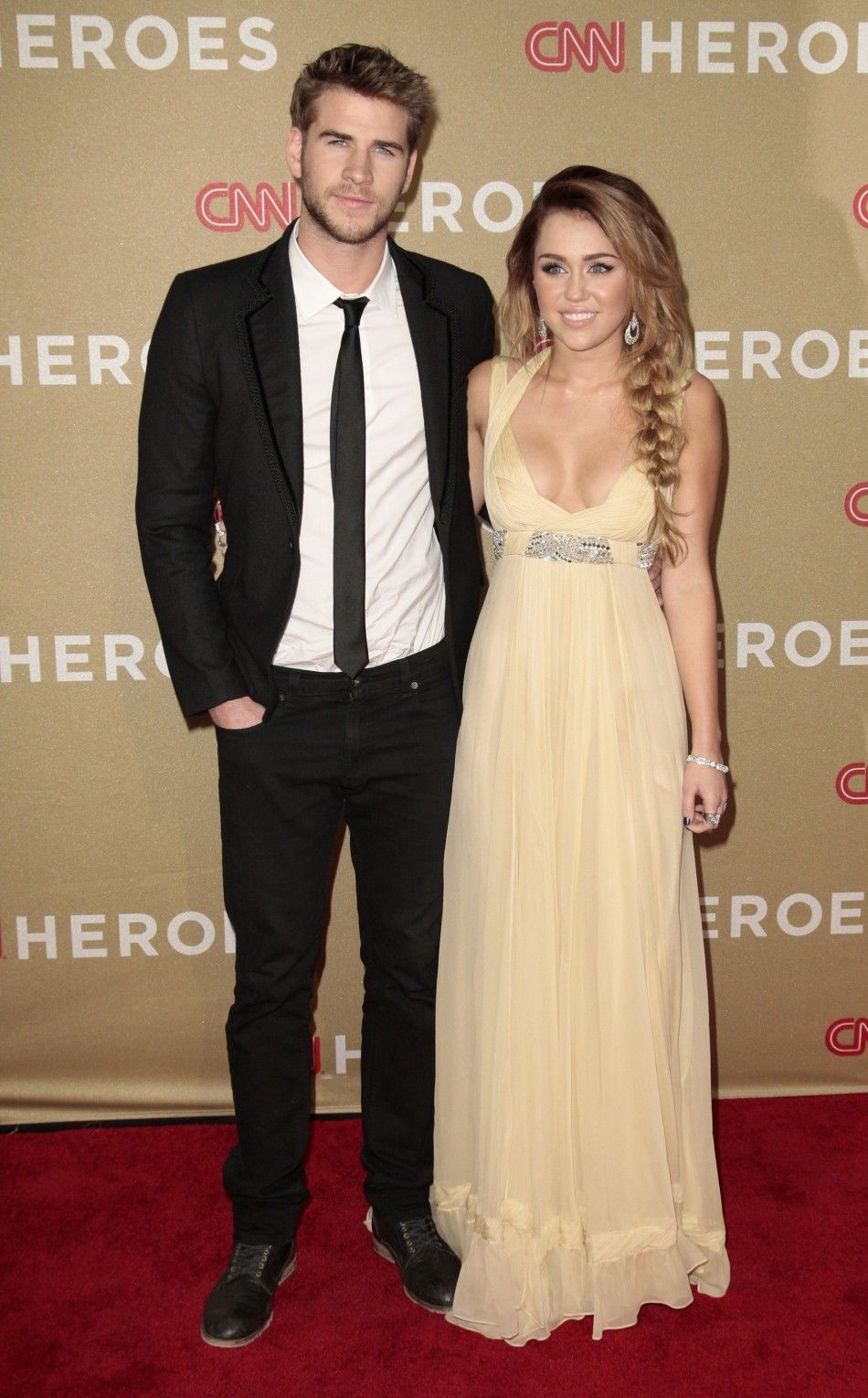 Actress and musician Cyrus and actor Hemsworth arrive at the CNN Heroes An All-Star Tribute event at the Shrine Auditorium in Los Angeles, California
