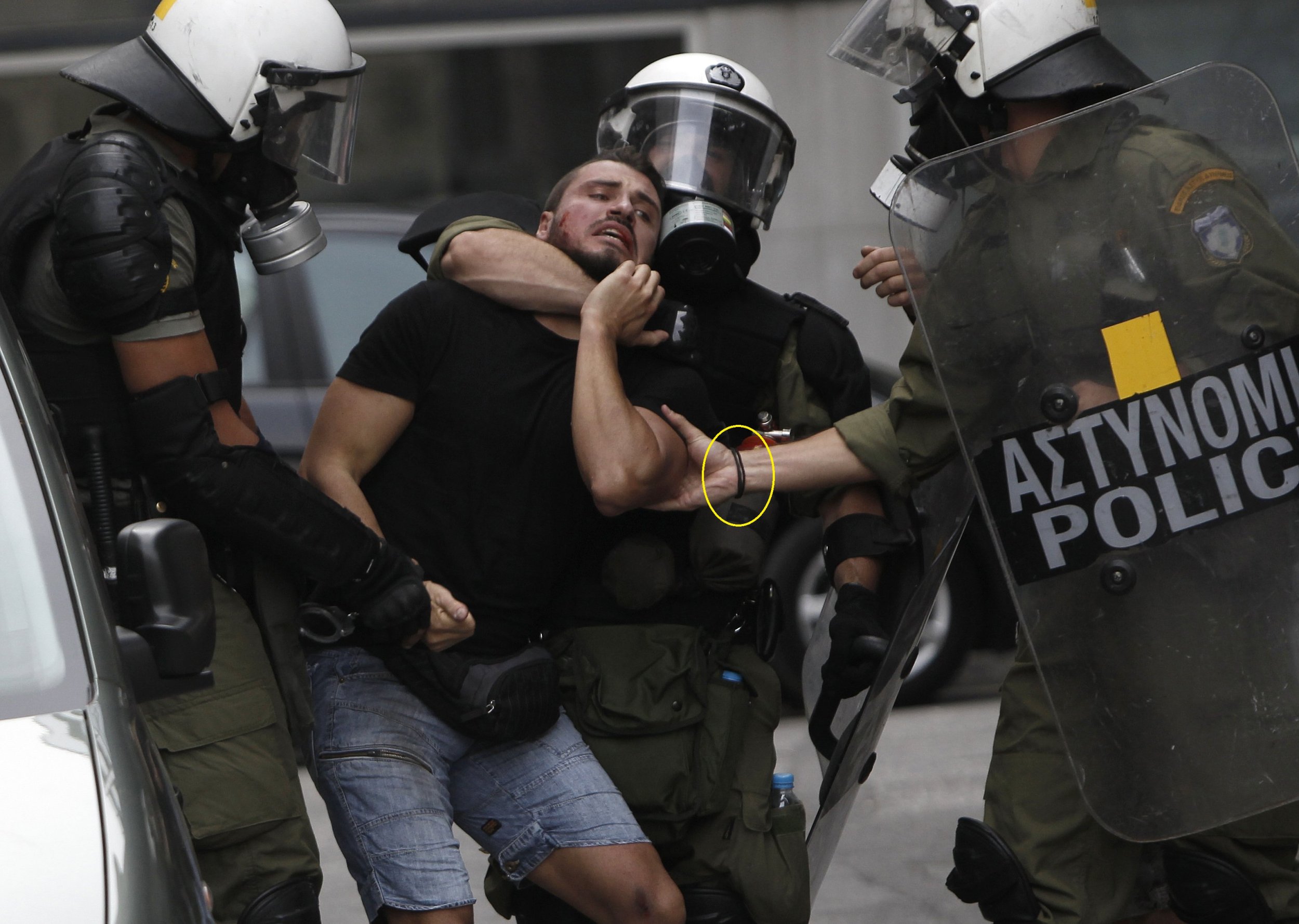 A protester is arrested during demonstrations in Athens in October 9.