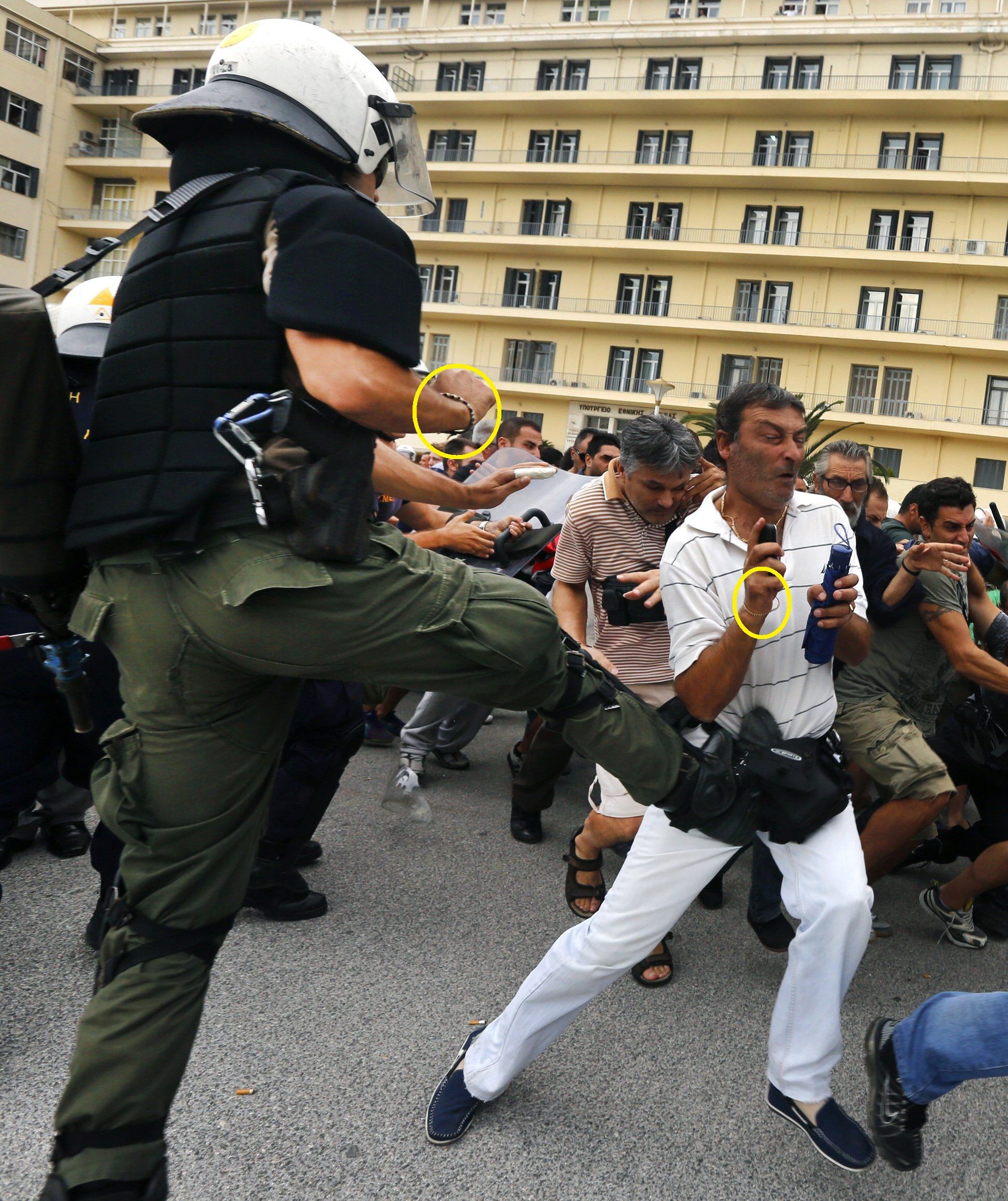 A riot policeman kicks a demonstrator during a protest at the Ministry of Defense on October 4.