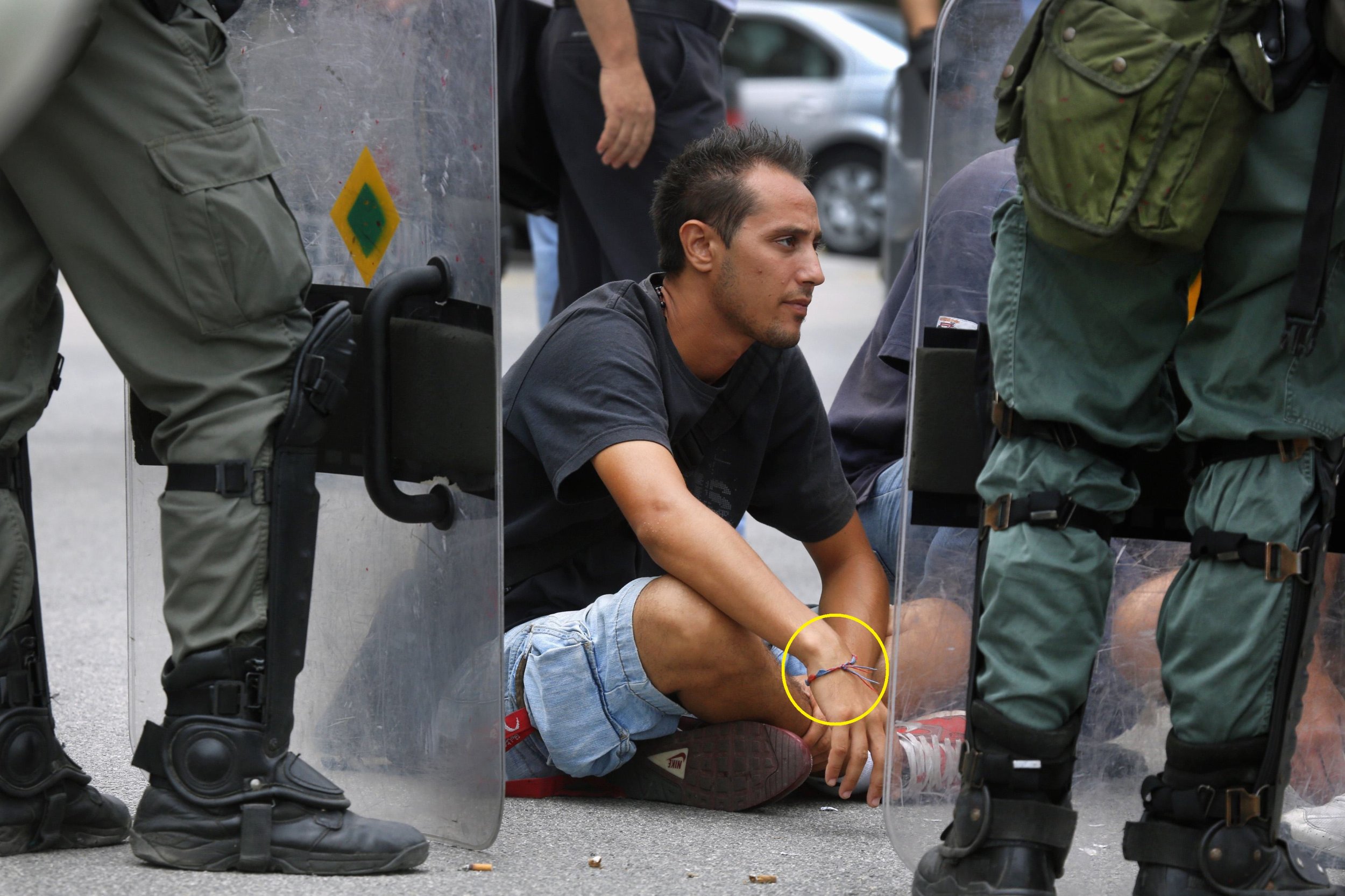 A demonstrator is detained during a protest at the Ministry of Defense on October 4.