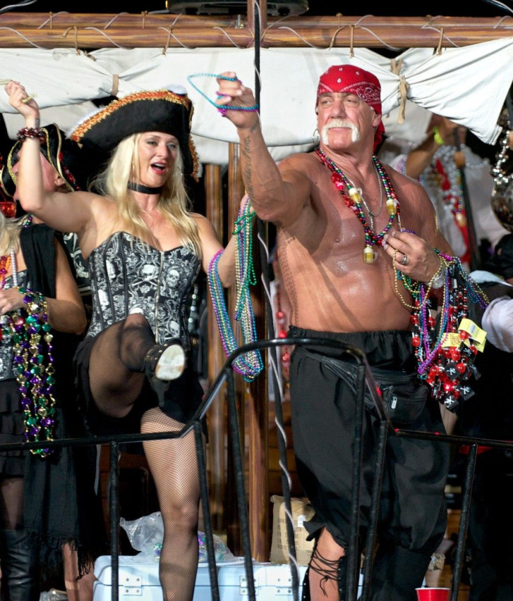 Hulk Hogan and his wife Jennifer toss beads to revellers at the Fantasy Fest Parade in Key West