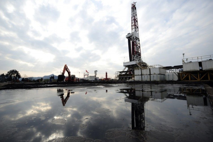 A natural gas appraisal well of Sinopec is seen behind a treatment pond of drilling waste in Langzhong county, Sichuan province March 1, 2011.