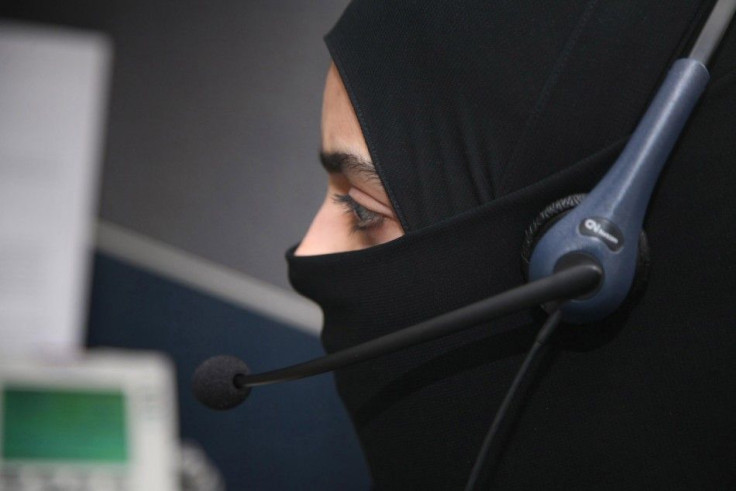 A female Saudi telephone operator works at the International Medical Center in Jeddah