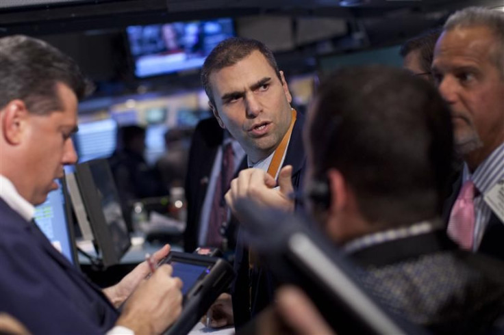 Traders work on the floor of the New York Stock Exchange at the end of the trading day in New York