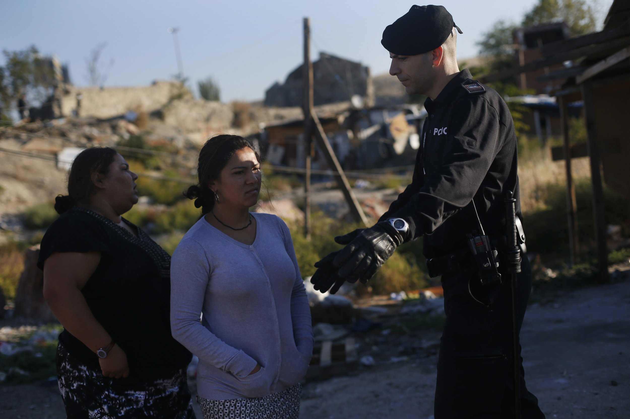 A woman is blocked from entering her former home, as Spanish police proceeded to demolish it, during an operation in Madrids El Gallinero slum.