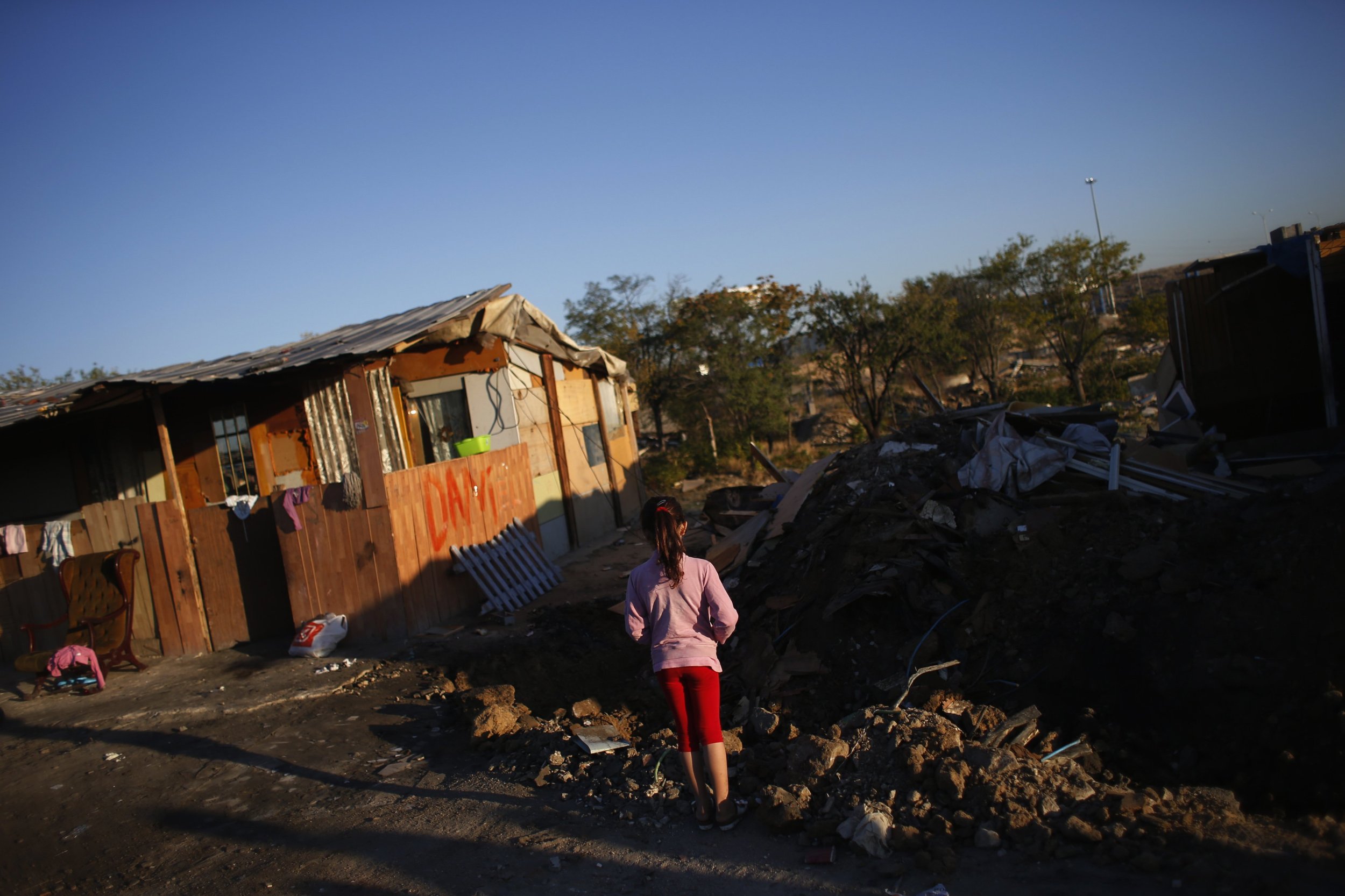A girl looks at the remains of a relatives shack after it got demolished in by police in Madrids El Gallinero slum.