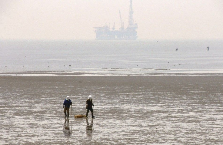 People walk along Bohai Bay