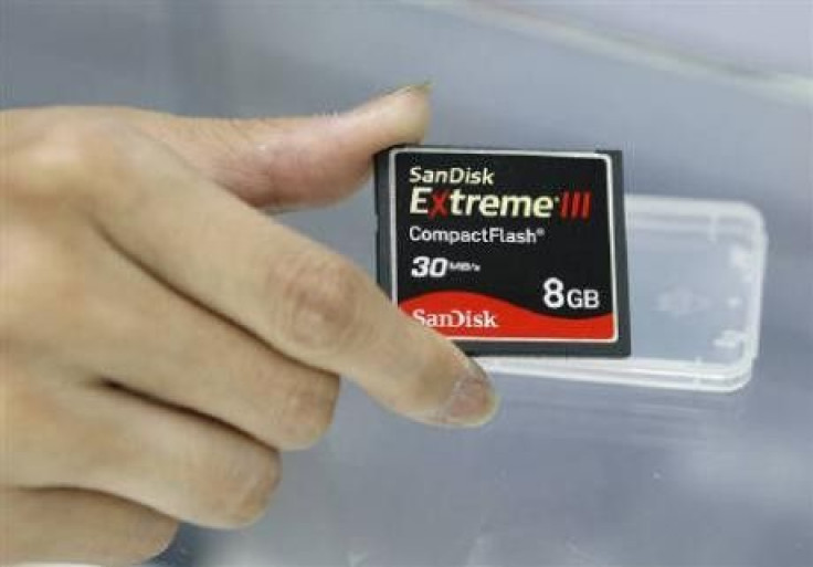 An employee of a computer shop poses with a SanDisk compact flash memory card 