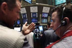 Traders gather around the General Motors trading post on the floor of the New York Stock Exchange