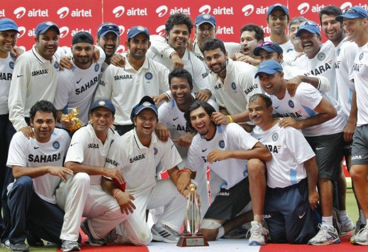 Members of Indian cricket team pose with the trophy after winning their third test match and the series against New Zealand in Nagpur.