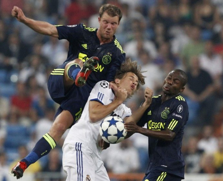 Real Madrid's Canales is challenged by Ajax's Tainio and Enoh during their Champions League soccer match in Madrid