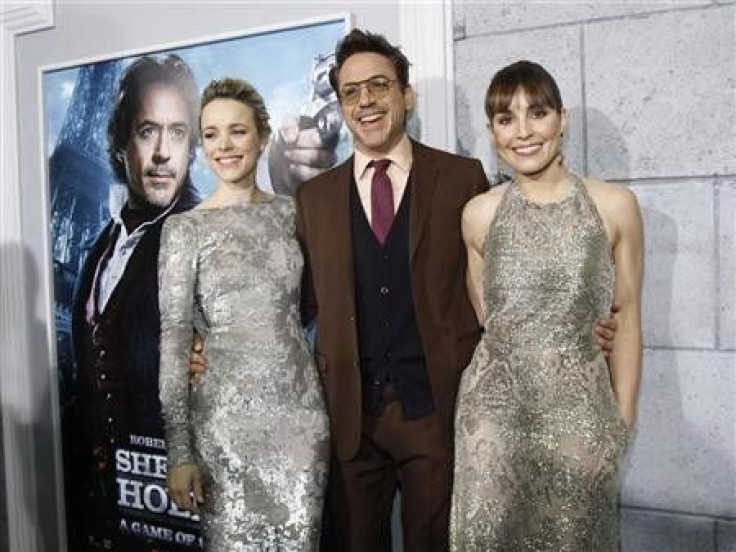 Cast members Robert Downey Jr. (C), Rachel McAdams (L) and Noomi Rapace pose at the premiere of ''Sherlock Holmes: A Game of Shadows'' at the Village theatre in Los Angeles, California
