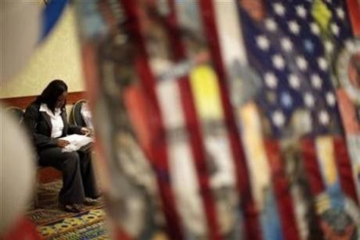 A woman fills out job application forms as she attends a job fair for military veterans and other unemployed people in Los Angeles, October 7, 2010.