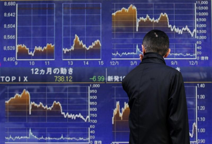A man looks at a stock quotation board outside a brokerage in Tokyo