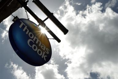 A sign hangs in front of a branch of travel agent Thomas Cook in London