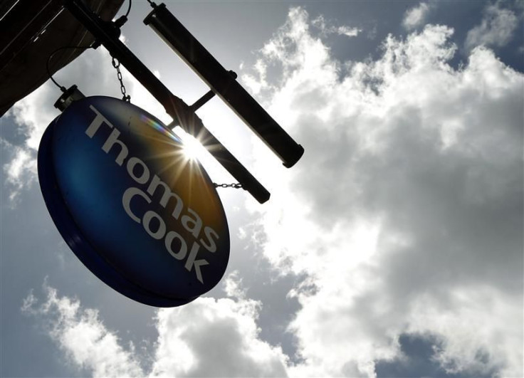 A sign hangs in front of a branch of travel agent Thomas Cook in London