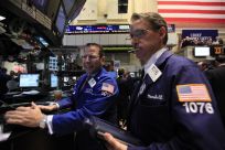 Specialist trader Mike Pistillo and Marshall Ryan work on the floor of the New York Stock Exchange