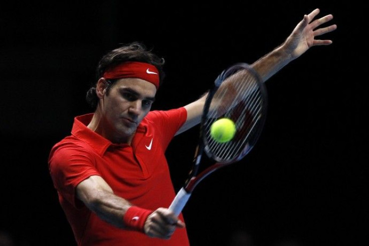 Switzerland's Roger Federer returns the ball to Britain's Andy Murray in their singles match at the ATP World Tour Finals in London.