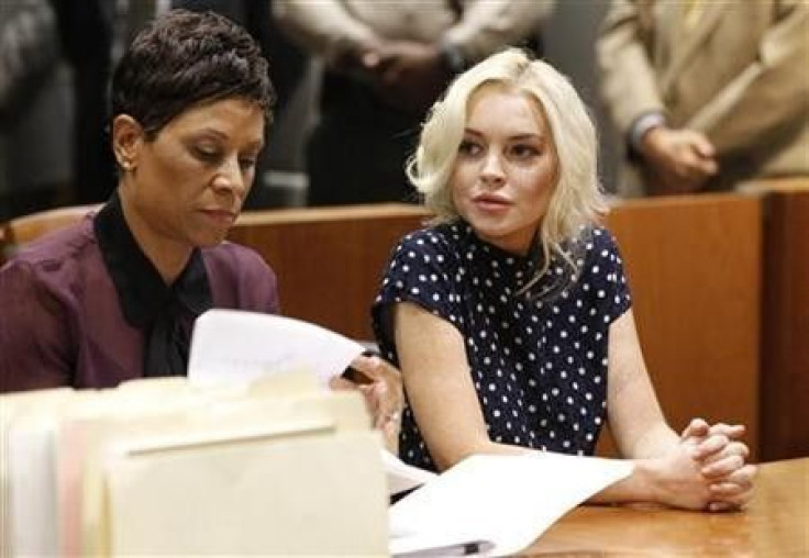 Actress Lindsay Lohan (R), accompanied by her attorney Shawn Chapman Holley, attends a probation violation hearing at Airport Branch Courthouse in Los Angeles