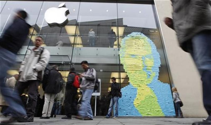 Adhesive notes show face of Apple co-founder and former CEO Jobs on window of apple store in Munich